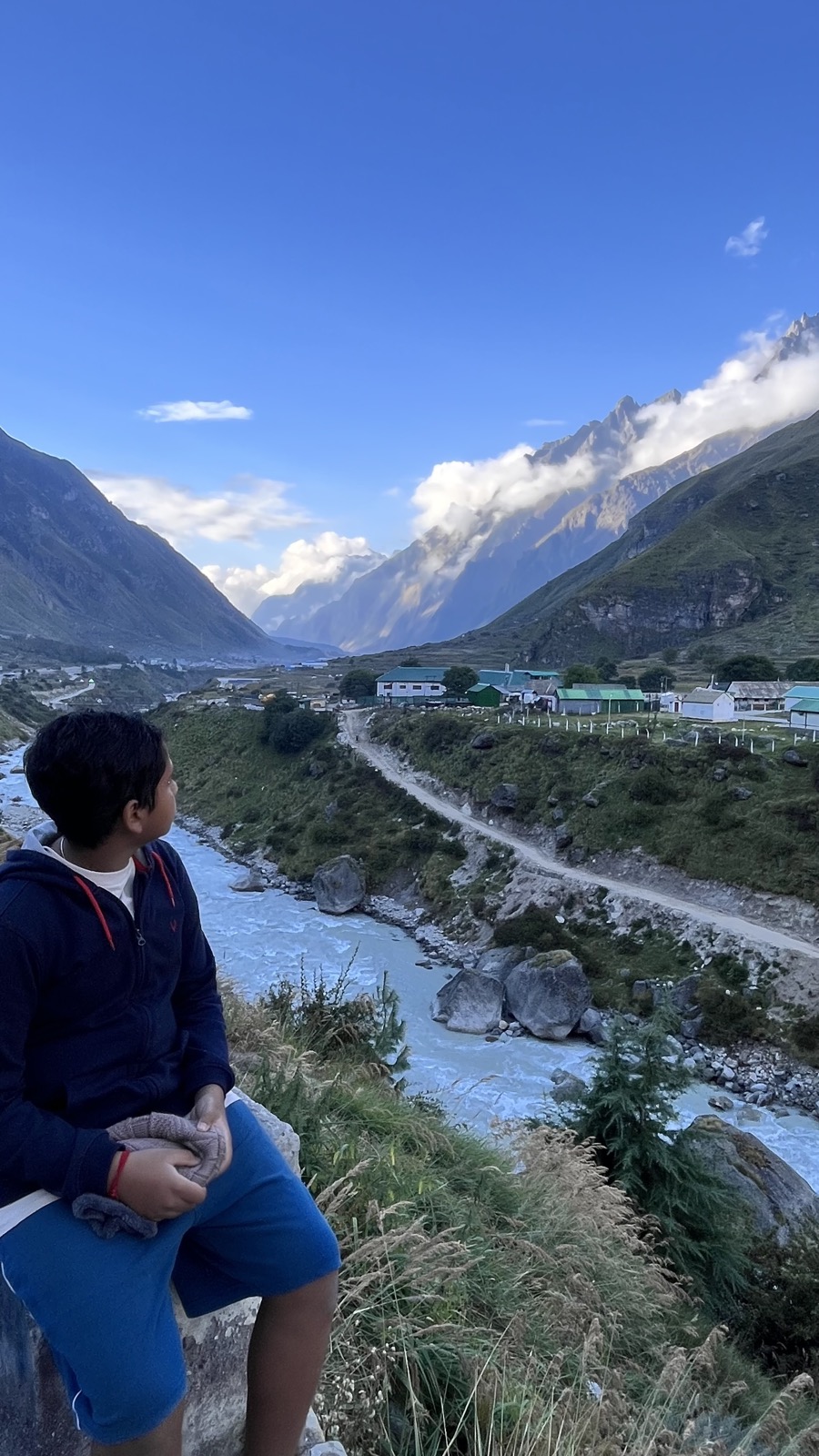 Boy overlooking valley near Badrinath