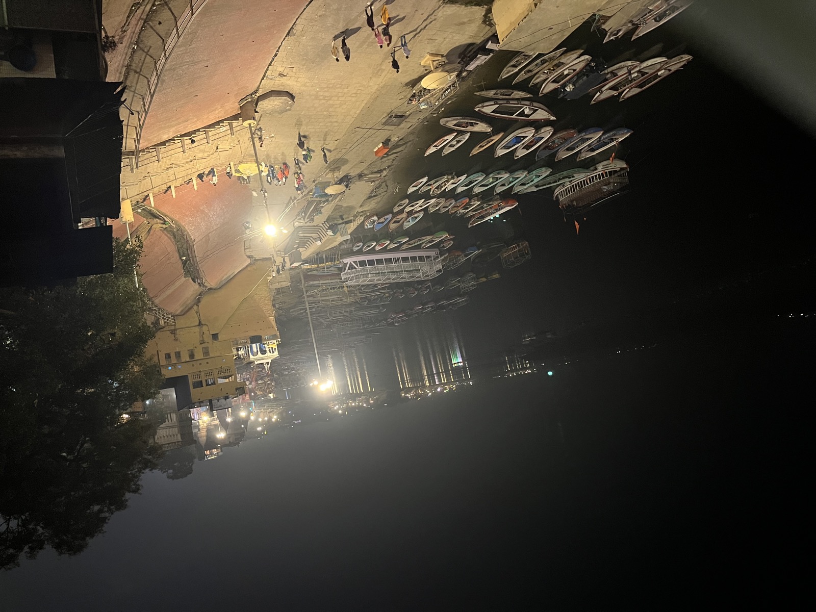 Ghats of Varanasi at night with boats